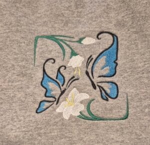 Open weave Embroidered butterflies and flowers on sweatshirt
