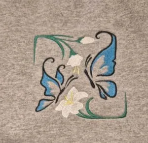 Open weave Embroidered butterflies and flowers on sweatshirt