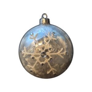 Snowflake ornament glistens in the lights with a white background