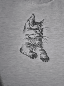 black cat with green eyes embroidered on a Fruit of the Loom sweatsahirt