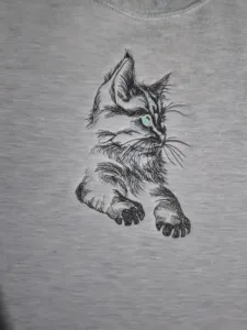 black cat with green eyes embroidered on a Fruit of the Loom sweatsahirt